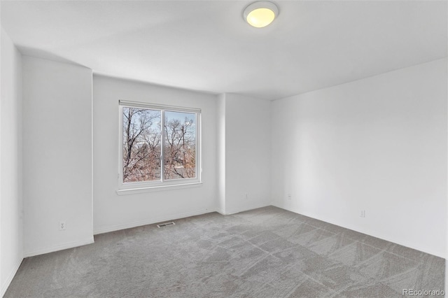 unfurnished room featuring carpet flooring and visible vents