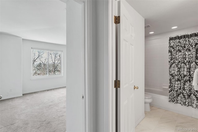 full bath with shower / tub combo, toilet, recessed lighting, and visible vents