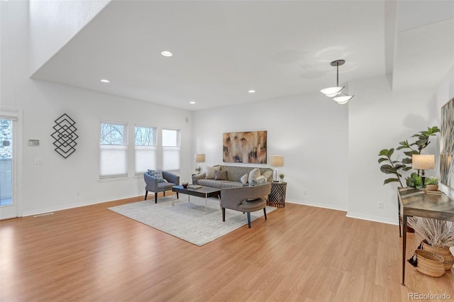 living area with recessed lighting, baseboards, and light wood-style floors