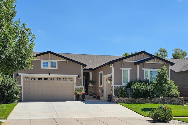 craftsman-style house featuring a garage and a front lawn