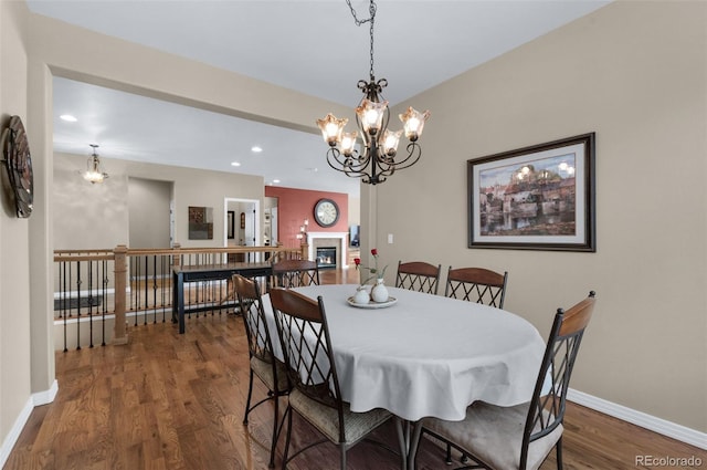 dining space featuring dark hardwood / wood-style flooring and a notable chandelier