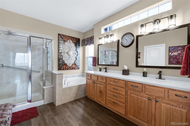 bathroom featuring vanity and independent shower and bath