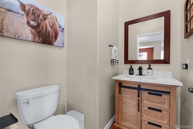 bathroom featuring toilet and vanity