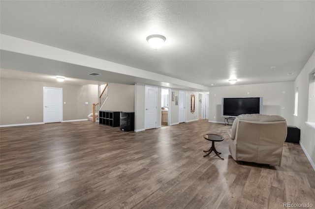 living room featuring a textured ceiling and hardwood / wood-style flooring