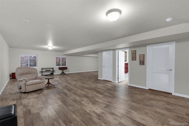 sitting room with a textured ceiling and dark hardwood / wood-style flooring