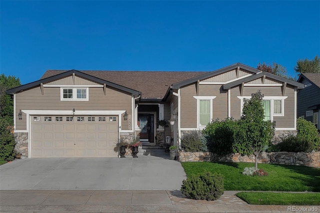 craftsman-style home with a front lawn and a garage