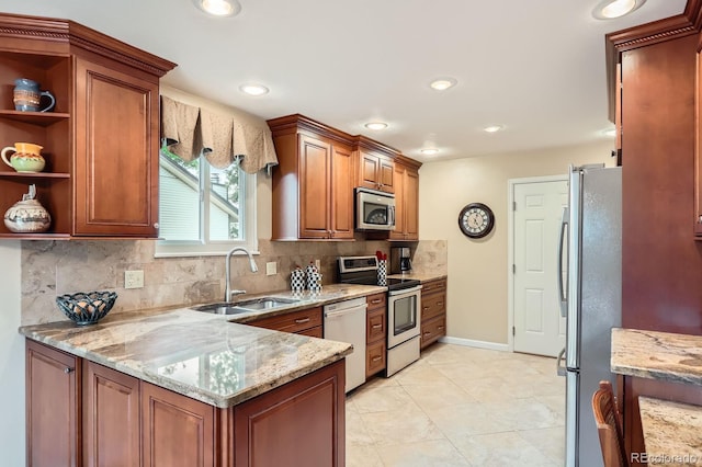 3544 Dyanna Dr, Thornton, CO 80241 - kitchen featuring appliances with stainless steel finishes, light stone counters, tasteful backsplash, a peninsula, and brown cabinets