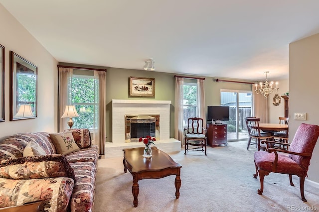 3544 Dyanna Dr, Thornton, CO 80241 - living room featuring a chandelier, carpet flooring, and a fireplace