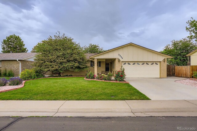 3544 Dyanna Dr, Thornton, CO 80241 - ranch-style house featuring brick siding, board and batten siding, an attached garage, and driveway