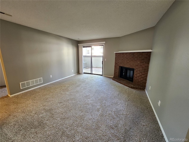 14499 E 1st Dr Unit A05, Aurora, CO 80011 - unfurnished living room with carpet, a fireplace, baseboards, and a textured ceiling