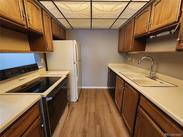 14499 E 1st Dr Unit A05, Aurora, CO 80011 - kitchen featuring electric stove, a sink, dishwasher, light wood-style floors, and baseboards