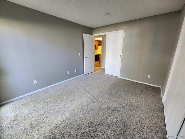 14499 E 1st Dr Unit A05, Aurora, CO 80011 - unfurnished bedroom with carpet, baseboards, and a textured ceiling