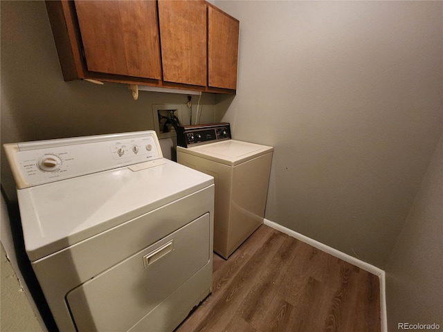 14499 E 1st Dr Unit A05, Aurora, CO 80011 - laundry area featuring cabinet space, independent washer and dryer, wood finished floors, and baseboards