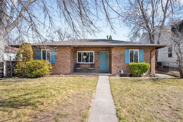 ranch-style house with brick siding, a front yard, and fence