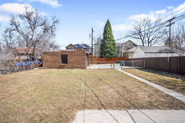 view of yard with a gate and a fenced backyard