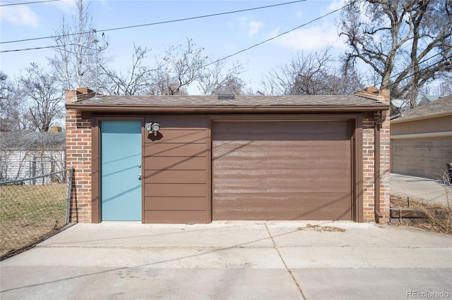 detached garage featuring fence