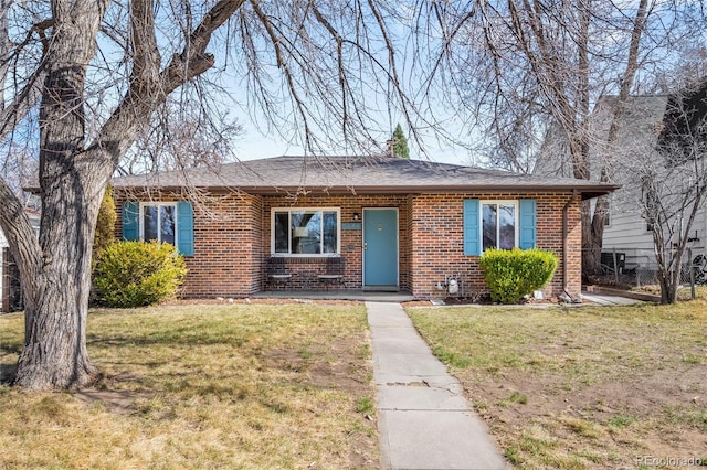 ranch-style house with brick siding and a front lawn