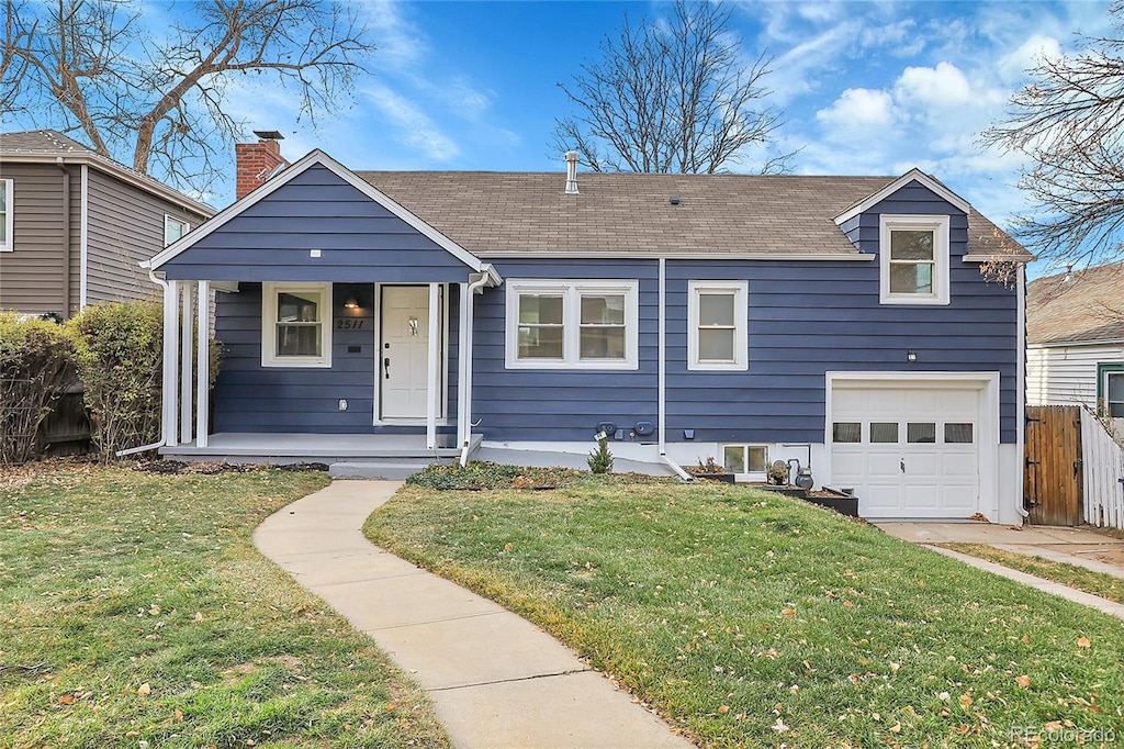view of front of house featuring an attached garage, a porch, fence, and a front yard