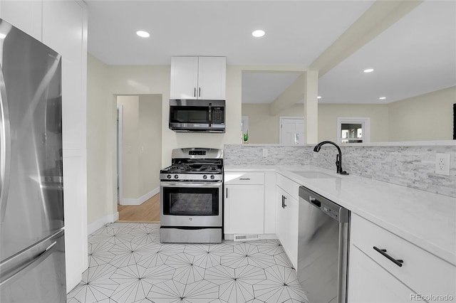 kitchen featuring white cabinetry, sink, and appliances with stainless steel finishes