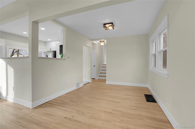 hallway featuring light hardwood / wood-style floors and a wealth of natural light