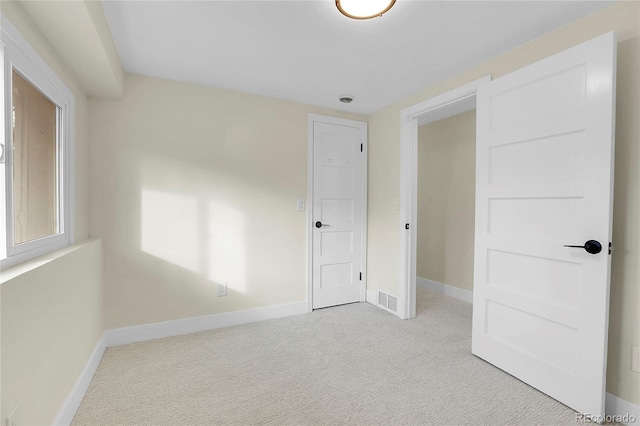 unfurnished bedroom featuring light colored carpet