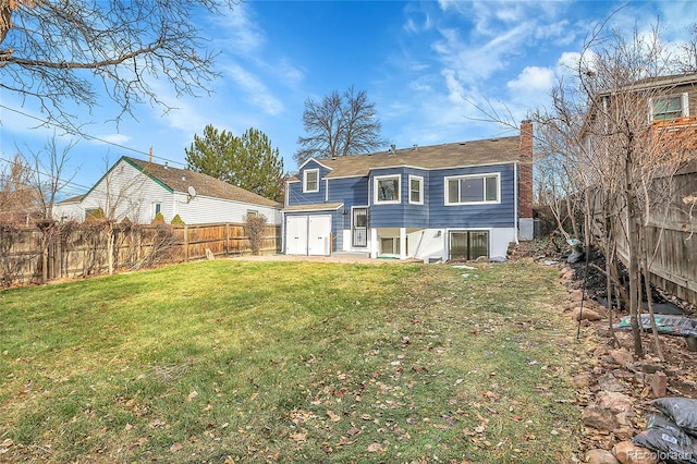 back of house with a lawn