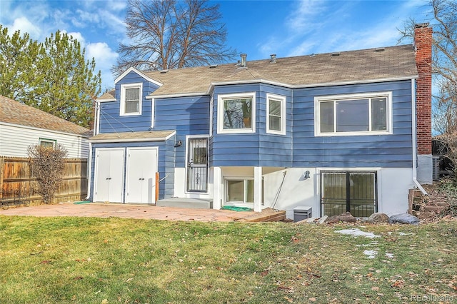 rear view of house with a lawn and a patio area