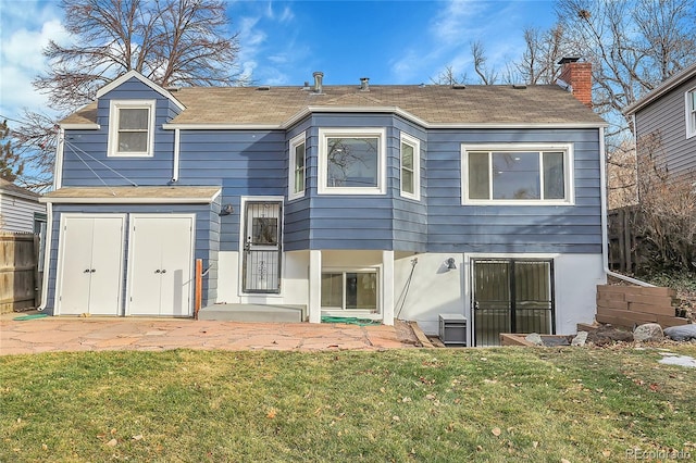 rear view of property with a yard and a patio