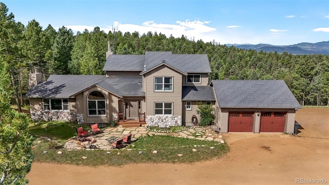 view of front of home featuring a garage and a mountain view