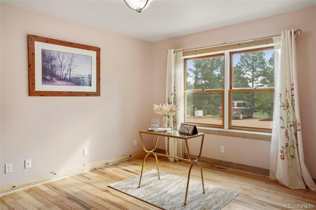 unfurnished office featuring light hardwood / wood-style flooring