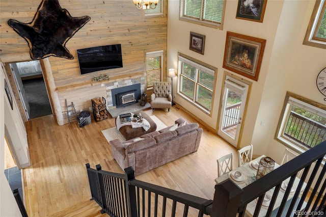 living room with a towering ceiling, light hardwood / wood-style floors, and a healthy amount of sunlight