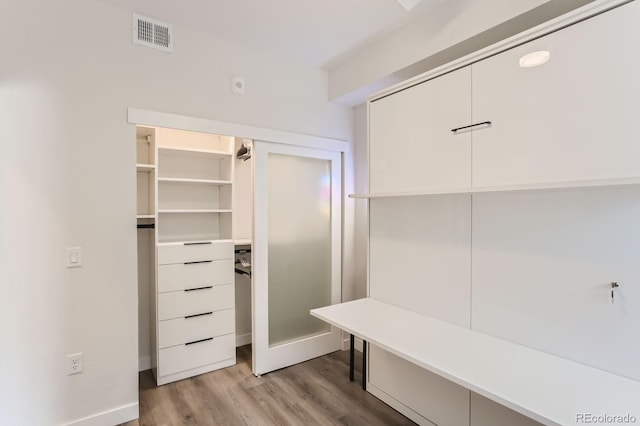 mudroom with light wood-style floors and visible vents