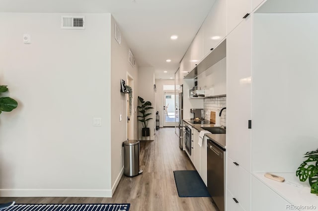 2120 N Downing St Unit 216, Denver, CO 80205 - kitchen featuring dishwasher, modern cabinets, white cabinetry, light wood-style flooring, and recessed lighting
