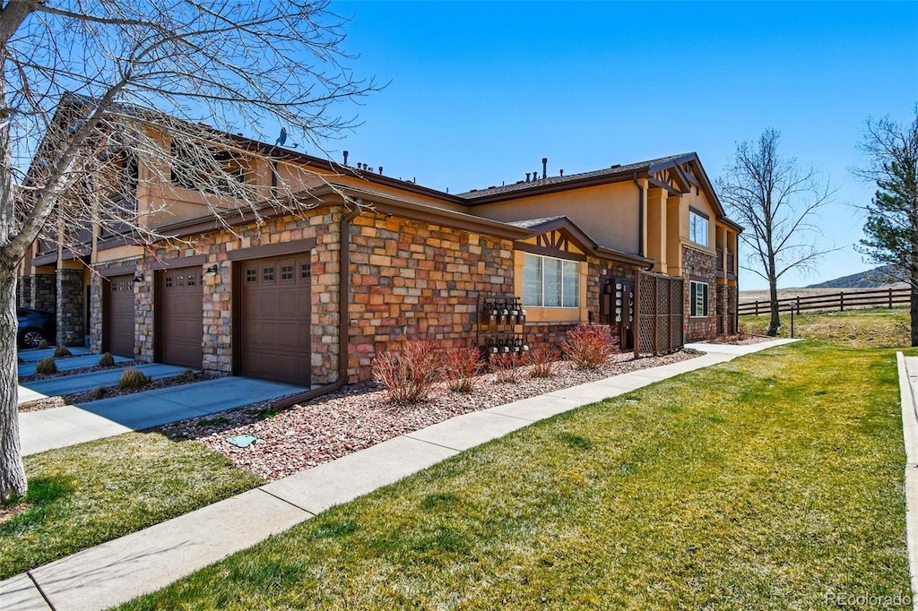 view of home's exterior featuring a garage, a yard, stucco siding, fence, and driveway