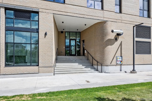 property entrance featuring brick siding