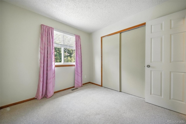 10106 Westside Cir, Littleton, CO 80125 - unfurnished bedroom with carpet flooring, a textured ceiling, and a closet