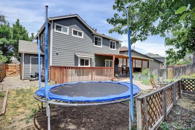 10106 Westside Cir, Littleton, CO 80125 - rear view of property featuring a trampoline and a fenced backyard