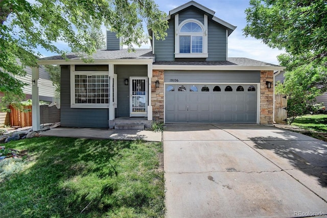 10106 Westside Cir, Littleton, CO 80125 - traditional-style home featuring stone siding, driveway, roof with shingles, an attached garage, and covered porch