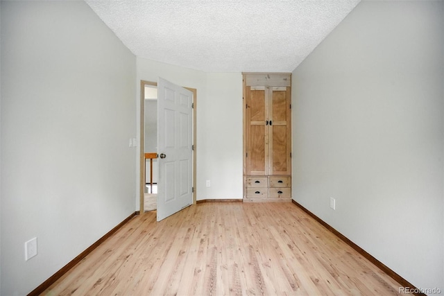 10106 Westside Cir, Littleton, CO 80125 - unfurnished bedroom with light wood-style flooring and a textured ceiling