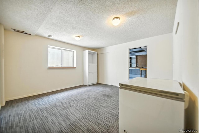 10106 Westside Cir, Littleton, CO 80125 - spare room featuring a textured ceiling and carpet floors