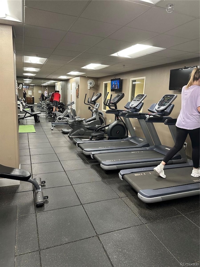 exercise room with a paneled ceiling
