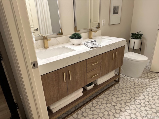 full bath featuring toilet, double vanity, and tile patterned floors