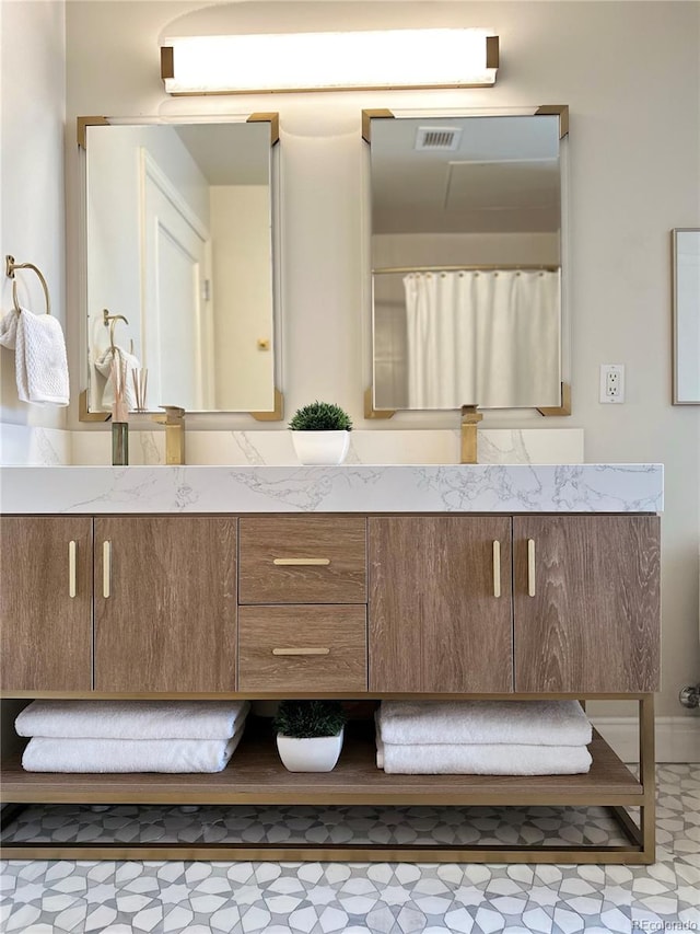 full bath with double vanity and tile patterned floors