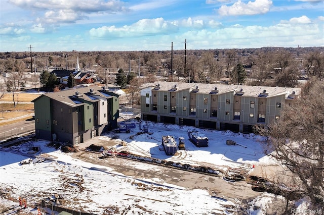 snowy aerial view with a residential view