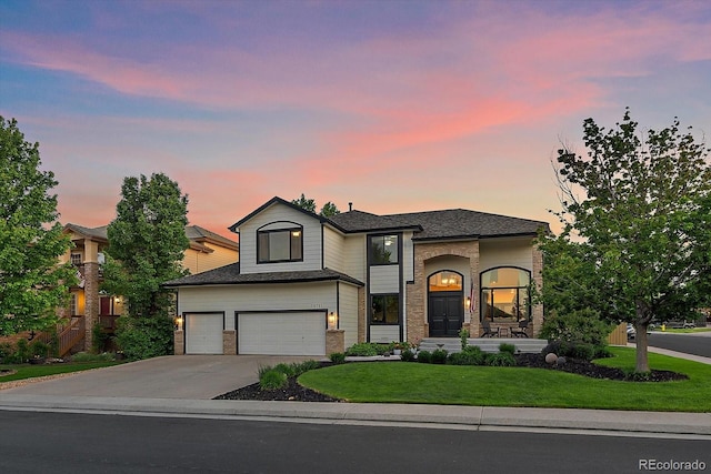 10701 Flagler Dr, Parker, CO 80134 - view of front facade featuring an attached garage, concrete driveway, a front yard, and brick siding