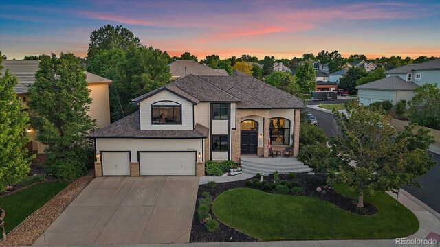 10701 Flagler Dr, Parker, CO 80134 - french country style house with driveway, brick siding, a garage, and a front yard