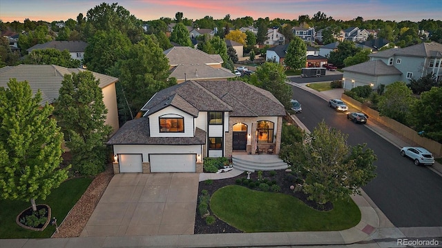 10701 Flagler Dr, Parker, CO 80134 - view of front facade with driveway, stone siding, a residential view, and an attached garage