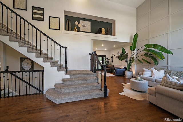 10701 Flagler Dr, Parker, CO 80134 - stairs featuring a towering ceiling and wood finished floors