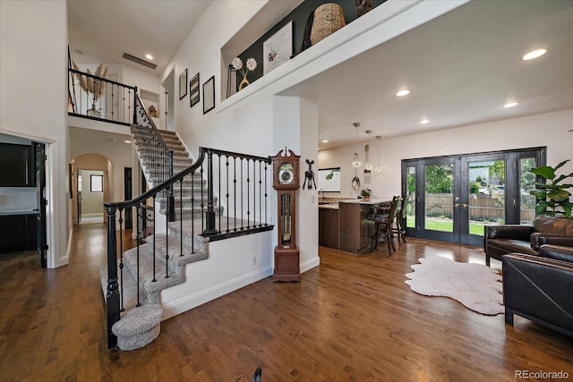 10701 Flagler Dr, Parker, CO 80134 - living area with french doors, arched walkways, stairs, dark wood finished floors, and recessed lighting