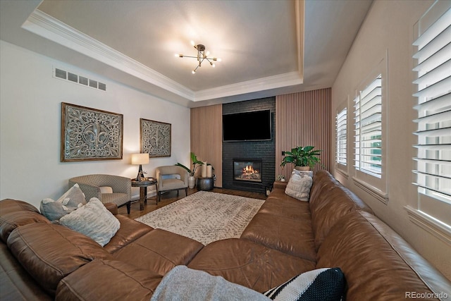 10701 Flagler Dr, Parker, CO 80134 - living area with a raised ceiling, wood finished floors, ornamental molding, and a fireplace
